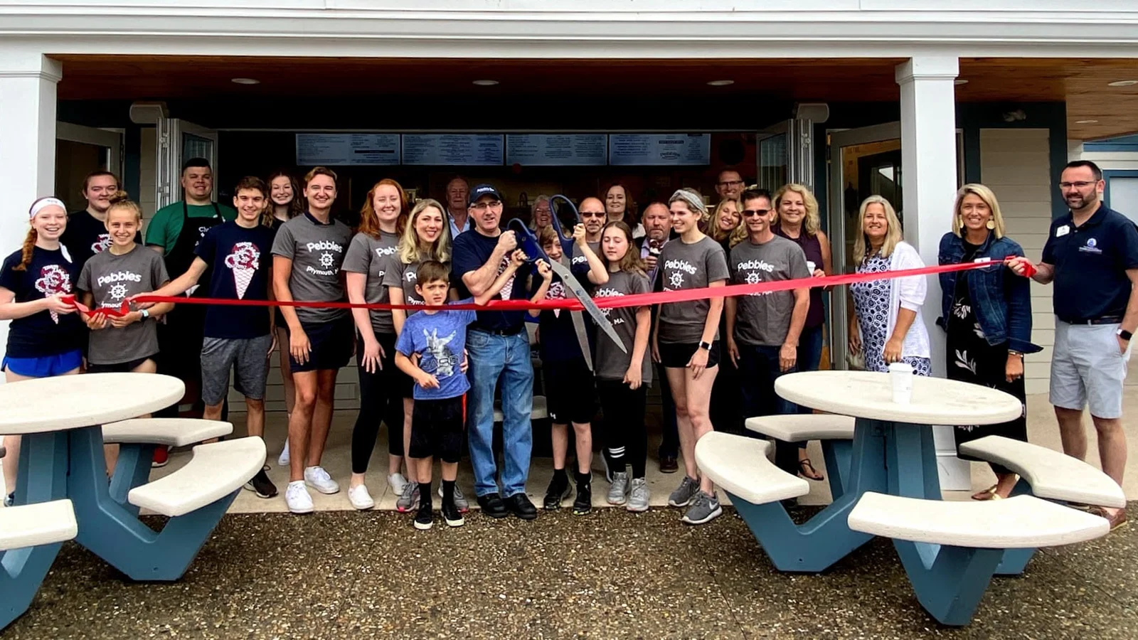 Pebbles Staff cutting ribbon